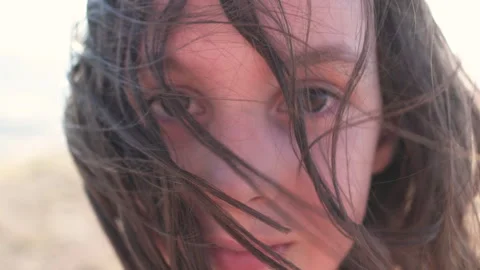 Portrait of a boy with long hair that develops in the wind. child with long hair 動画素材 248908239