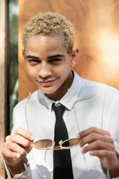 Portrait of boy looking at camera with glasses in his hand and sensual gaze Stock Photos
