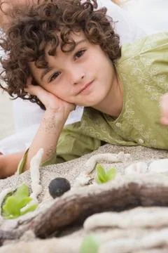 Portrait of a boy lying on the beach Stock Photos