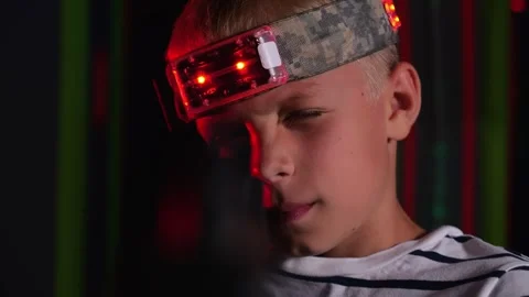 Portrait of a boy with a marker on his head and a laser tag weapon. Stock Footage 321815046