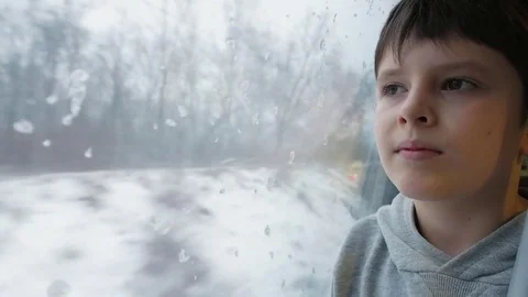 Portrait of a Boy in the Passenger Car Looking Out Through the Train Window o 스톡 동영상 84852070