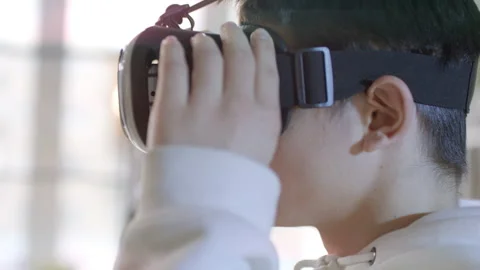 Portrait Of Boy Putting On VR Headset Stock Footage 141983525
