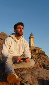 Portrait of boy sitting with a lighthouse Stock Photos