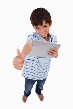 Portrait of a boy using a tablet computer with the thumb up Stock Photos
