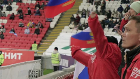 Portrait of a boy waving a Russian flag at a football stadium Stock Footage 178487432