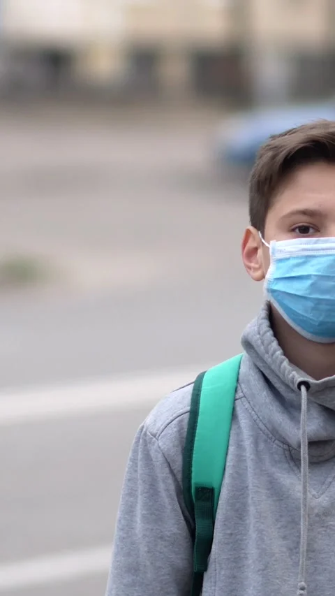 Portrait of boy wearing protective mask outdoors. Health and safety concept Stock Footage 302387533