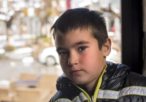 Portrait of a boy at the window Stock Photos