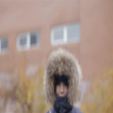 Portrait of a boy in winter jacket with hood on his head Stock Footage 69623159