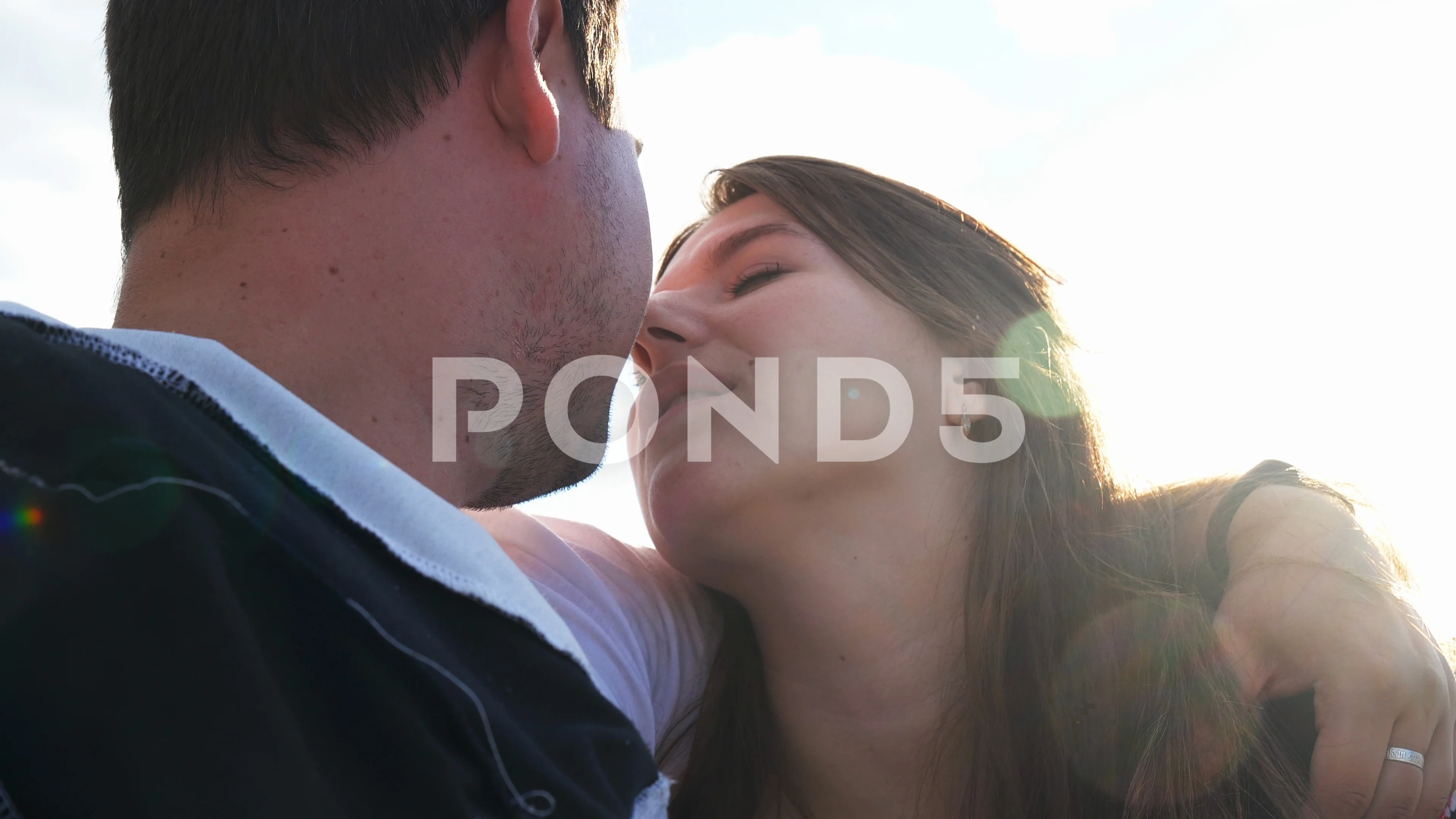 Portrait boyfriend and girlfriend when they kiss closeup background blue  sky 4K.