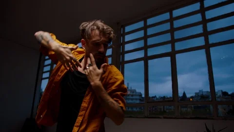 Portrait of breathtaking performance of handsome young man dancing at evening Stock Footage 109365953