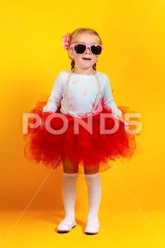 A portrait of a bright young pretty girl in skirt and sunglasses. Summer brig Stock Photos