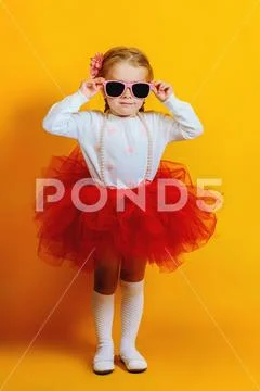 A portrait of a bright young pretty girl in skirt and sunglasses. Summer brig Stock Photos