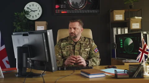 Portrait of British intelligence officer working on computer in command center Stock Footage 333306768
