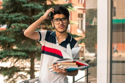 Portrait of a brooding guy with books Stock Photos