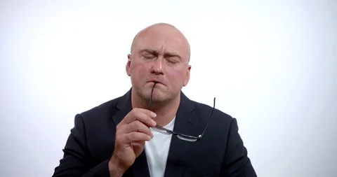 A portrait of a brooding middle-aged bald businessman wearing glasses and a Stock Footage 119113930
