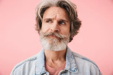Portrait of brooding old man with gray beard thinking and looking at copyspac Stock Photos