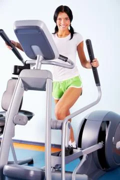 Portrait of brunette doing exercises on the simulator Stock Photos