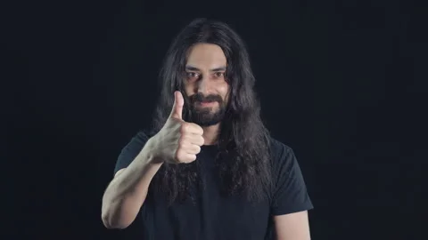 Portrait of a brunette eastern man with a long curly hair, beard and mustache on Stock Footage 107373349