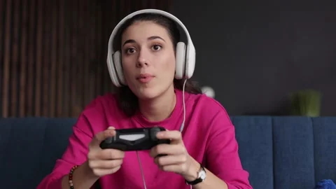 Portrait brunette female play game and win. Young woman is using virtual reality Stock Footage 166364506