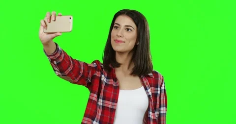 Portrait of the brunette good looking young woman in the red motley shirt making Video stock 89948752