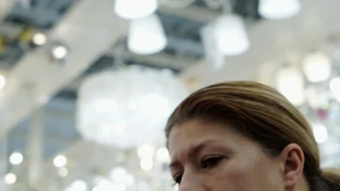 Portrait of a brunette in a lamp store. Video stock 153051616