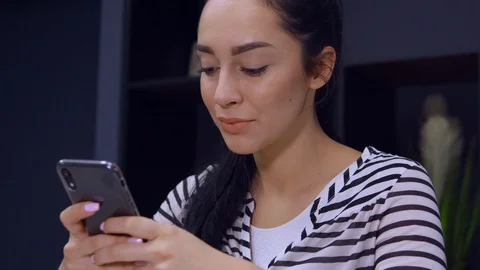 Portrait brunette typing message on mobile at work Stock Footage 113444900