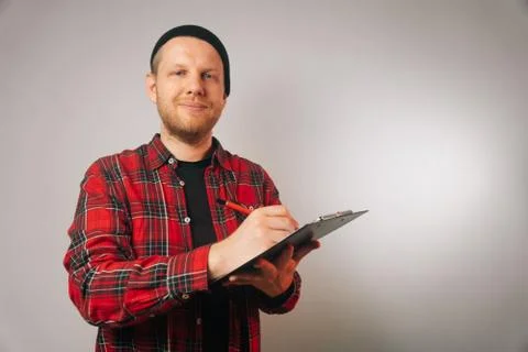 Portrait of a brutal successful builder, on a light background. average plan  Stock Photos