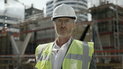 Portrait of builder in helmet posing on construction site Video stock 167024567
