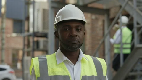 Portrait of builder looking at camera with calm face outdoor Stock Footage 196349809