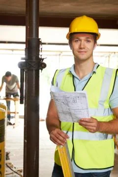 Portrait Of Builder On Site With Plans Stock Photos