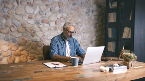 Portrait of business man working on computer while drinking coffee. Stock Footage 135719806