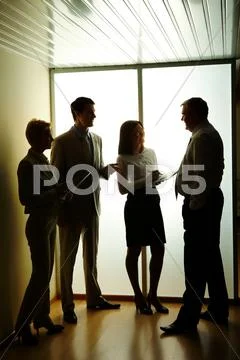 Portrait of business partners discussing or planning work at meeting Stock Photos