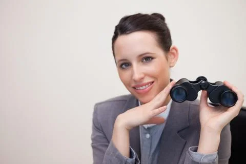 Portrait of business woman with binoculars smiling Stock Photos