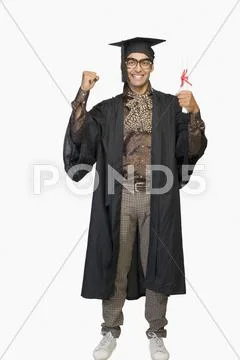 Portrait of a businessman in a graduation gown holding a diploma Stock Photos