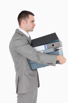 Portrait of a businessman holding a stack of binders Foto stock