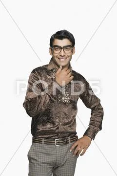Portrait of a businessman smiling with his hand on chin Stock Photos