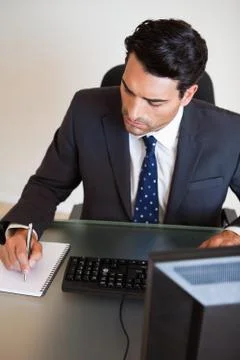 Portrait of a businessman taking notes Stock Photos