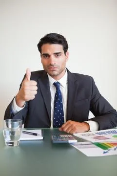 Portrait of a businessman with the thumb up Stock Photos