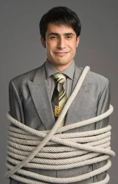 Portrait of a businessman tied up with ropes Stock Photos