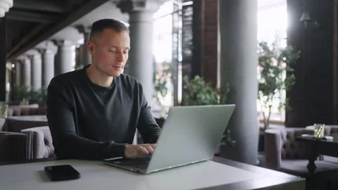 Portrait Of Businessman Using Laptop In Cafe, Freelancer Man With Gadget Surfing Stock Footage 247973360