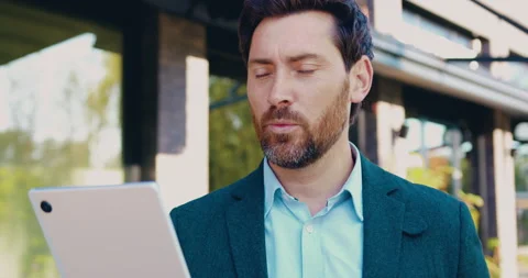 Portrait of businessman using tablet for video call outdoors Stock Footage 348647392