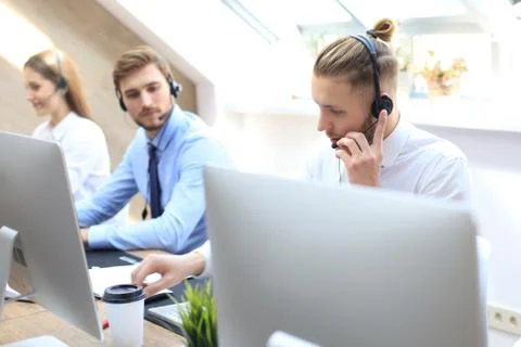 Portrait of call center worker accompanied by his team. Stock Photos
