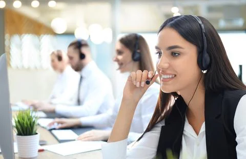 Portrait of call center worker accompanied by his team. Smiling customer su.. Stock Photos
