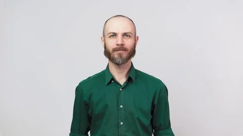Portrait of calm bearded man looking at camera isolated over white background. Stock Footage 127034744