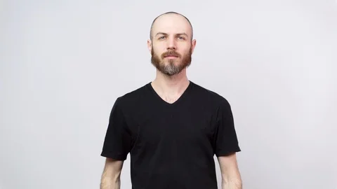 Portrait of calm bearded man looking at camera isolated over white background. Stock Footage 127425320
