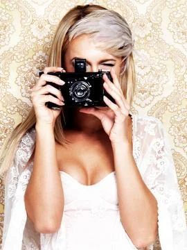 Portrait, camera and a bride in a wedding dress on a floral pattern in studio to Foto stock