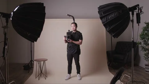 Portrait of a Cameraman with a Stabilizer on His Camera Video stock 208766326