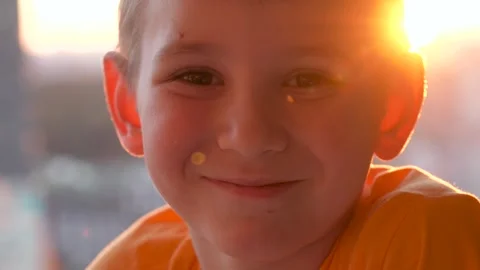 Portrait capturing playful boy with city skyline in background Stock Footage 326130371