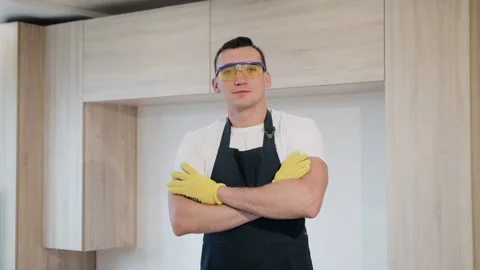 Portrait of carpenter smiling and standing in flat with new just made furniture Stock Footage 130452562