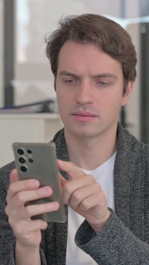 Portrait of Casual Young Man Using Phone, vertical video Stock Footage 324792956